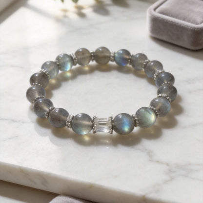 Labradorite bracelet on a marble surface with a soft focus background