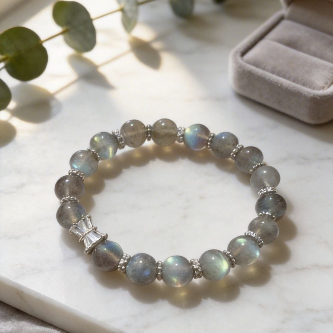 Labradorite bracelet on a marble surface with a softbox light